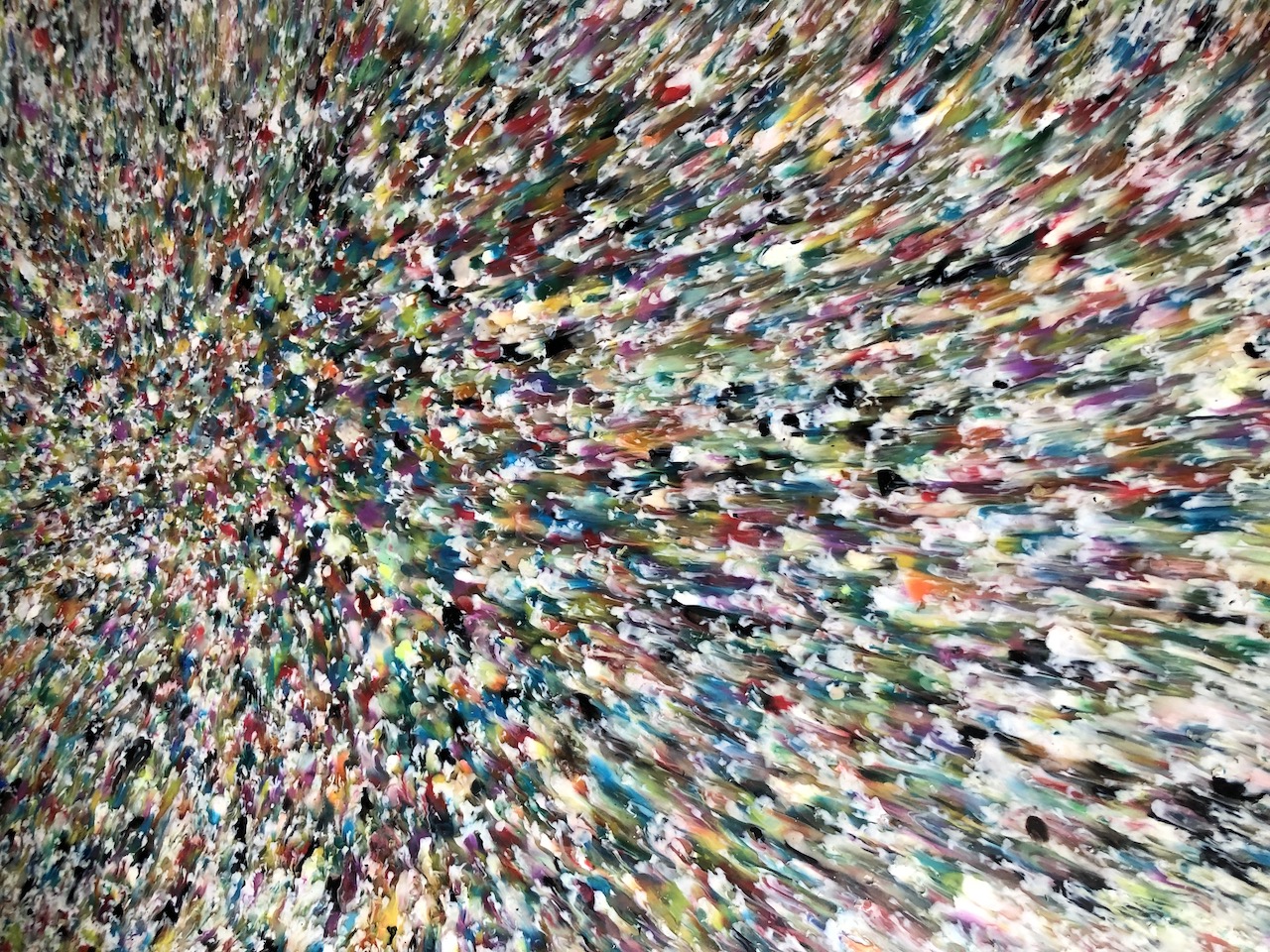 Colorful recycled plastic sheet made by Trash-o-Love in Taiwan, showcasing a swirl of melted PP, PE, and PS materials